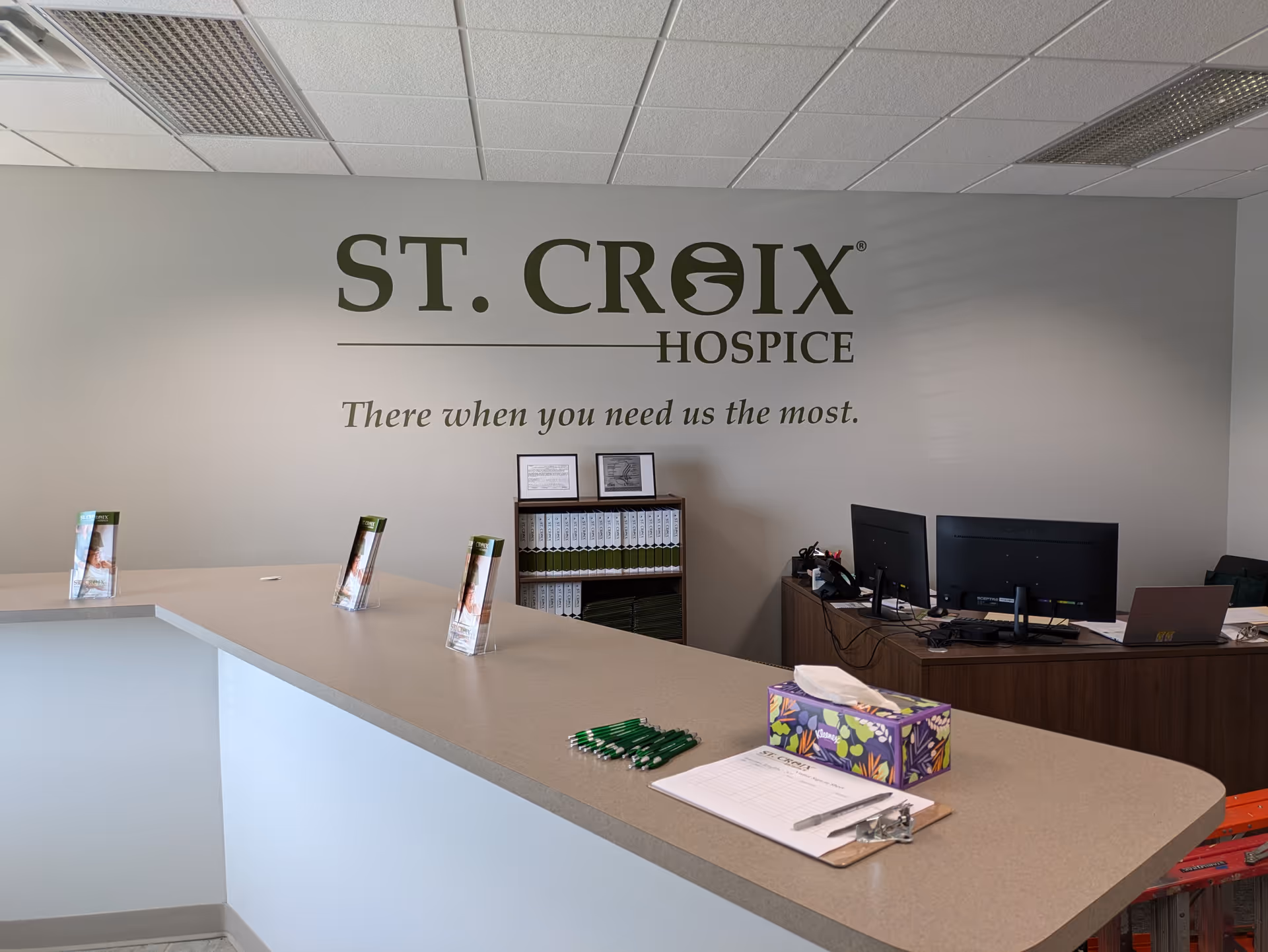Reception area featuring a curved counter and St. Croix Hospice logo on the wall.