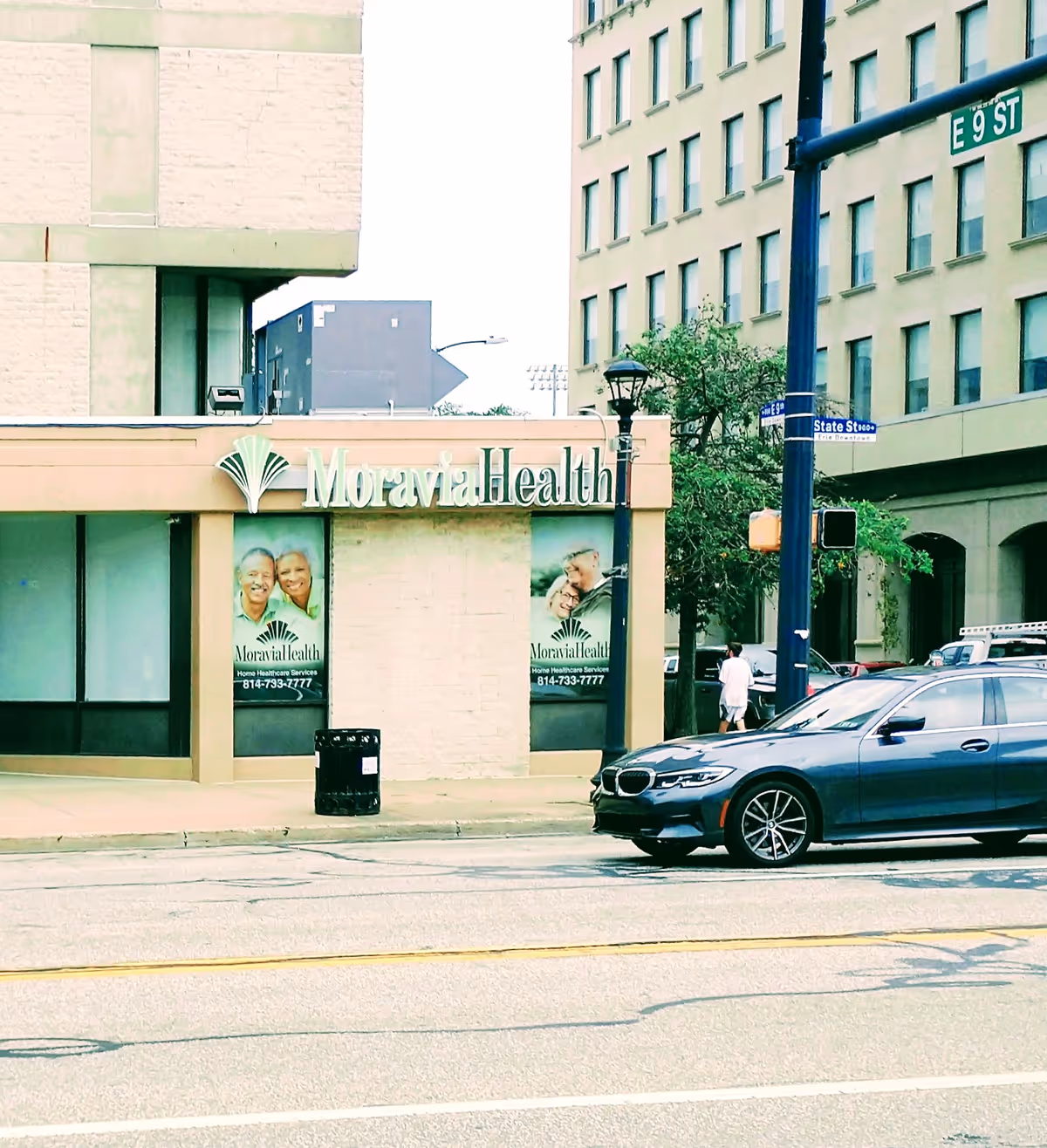 Street view of Moravia Health storefront on a city block with a parked car nearby.
