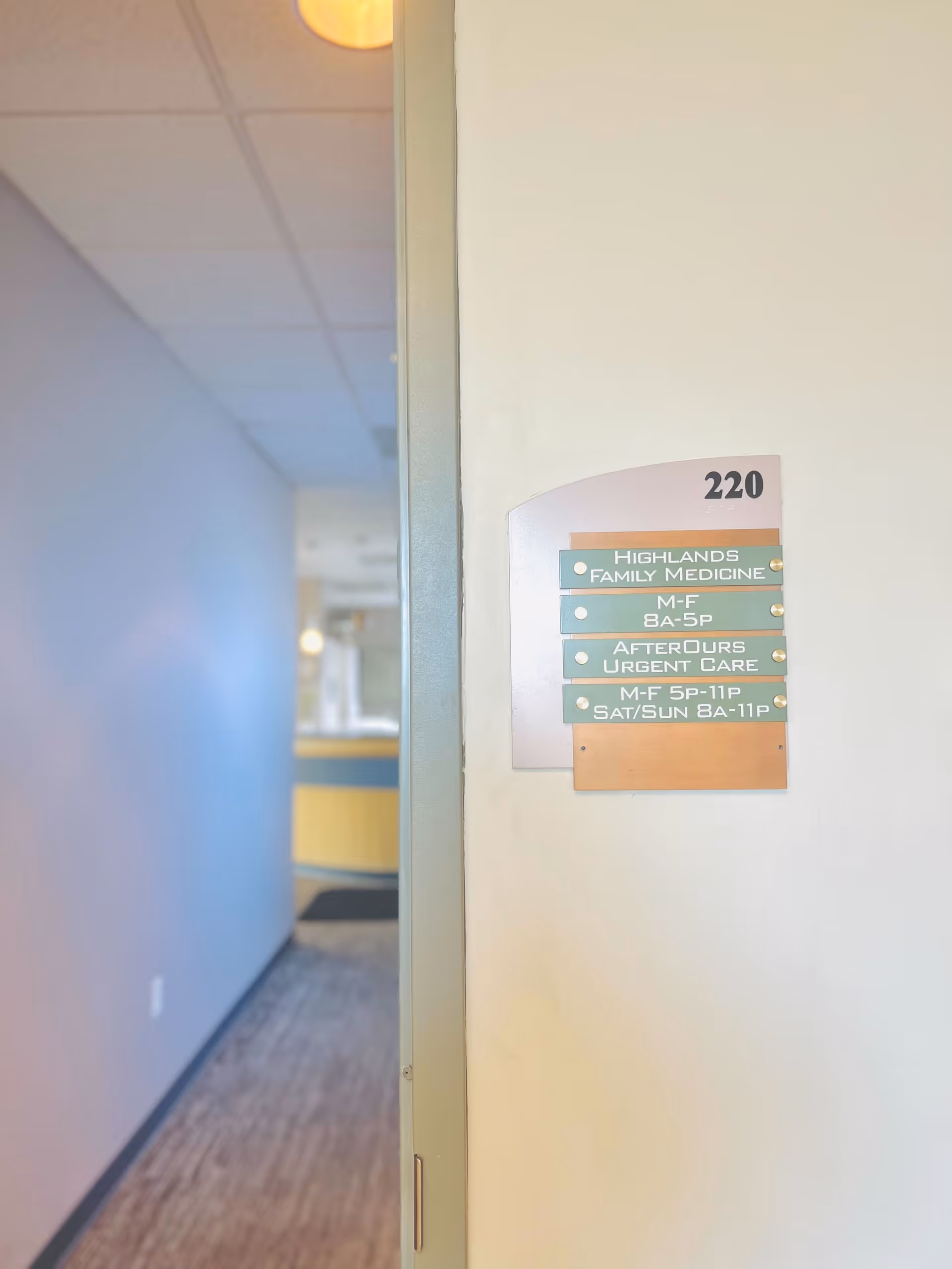 Interior hallway with door sign listing Highlands Family Medicine and AfterOurs Urgent Care