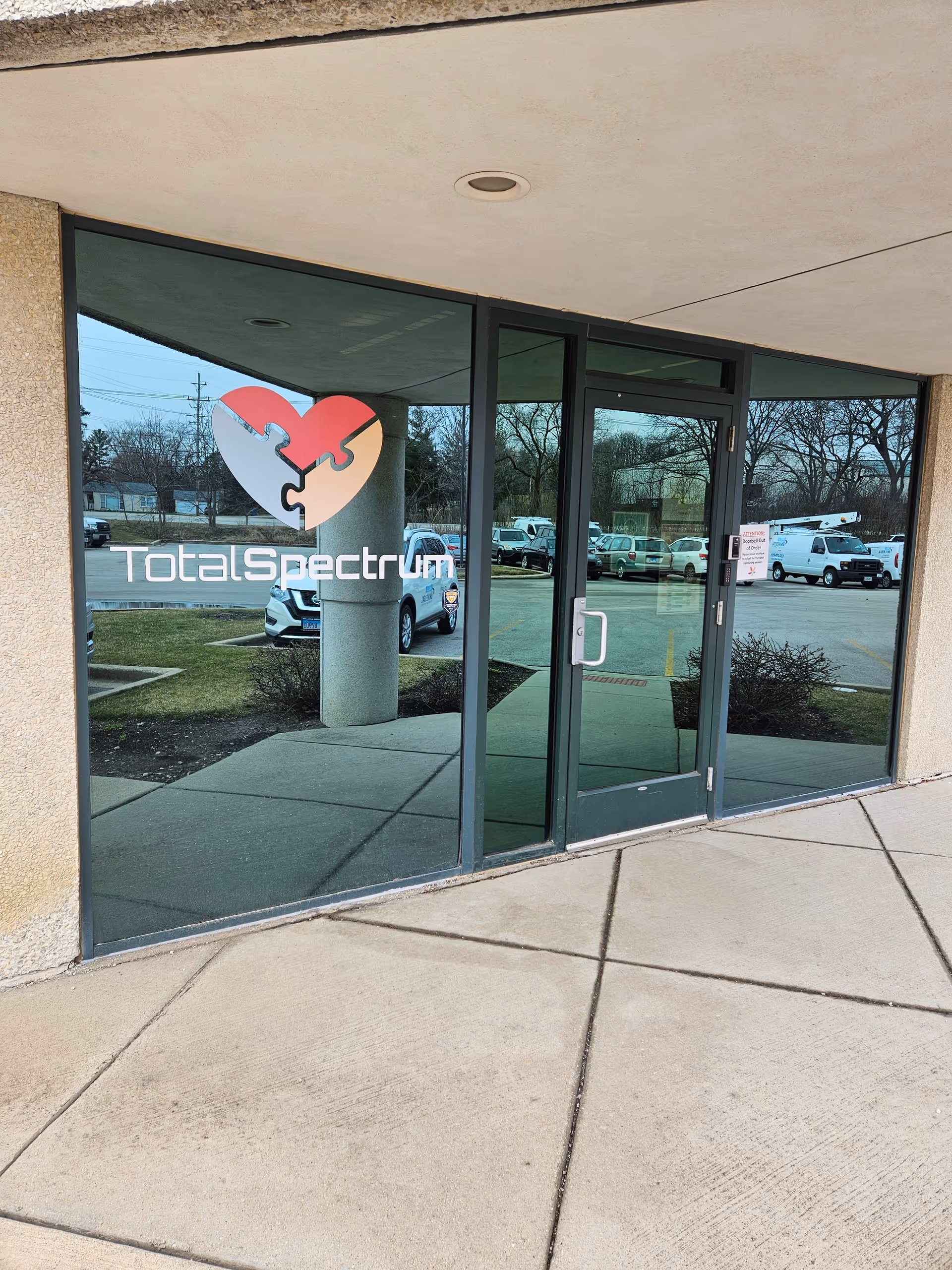 Front glass doors display Total Spectrum ABA logo at facility entrance.