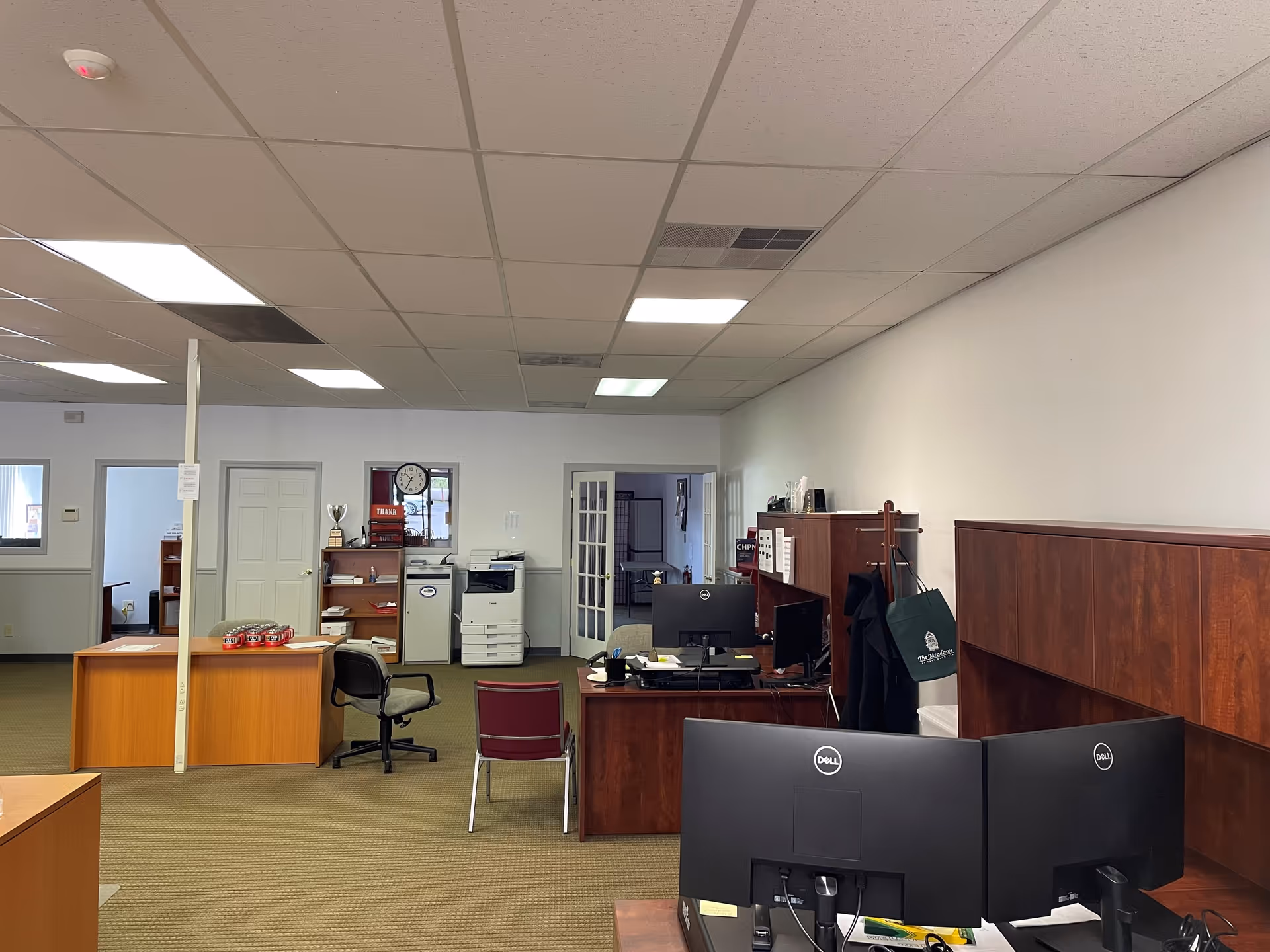 Interior office area with desks, computers, and filing cabinets in a BAYADA Hospice facility.