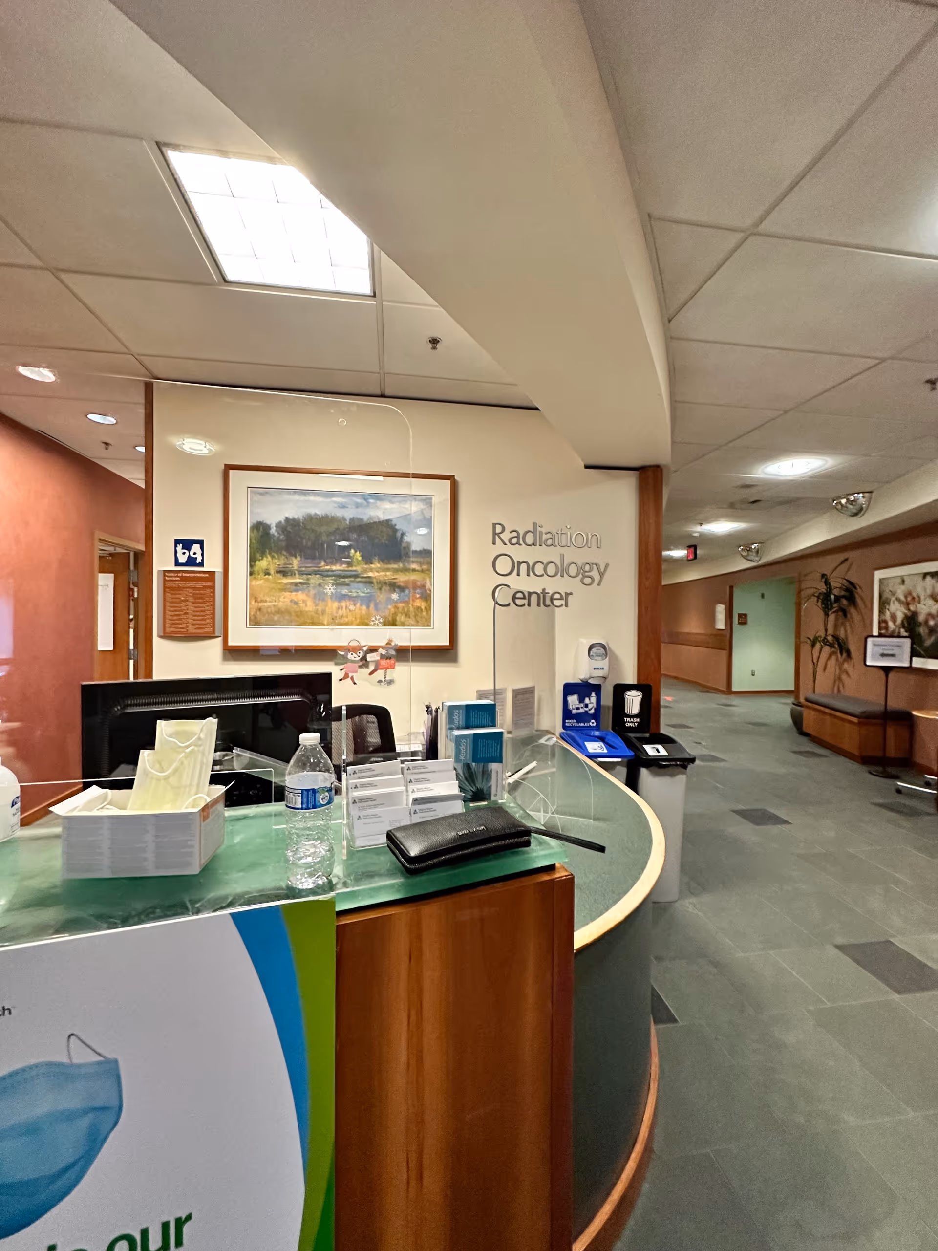 Reception area at St. Francis Hospital Radiation Oncology Center with desk, signage, and hallway.
