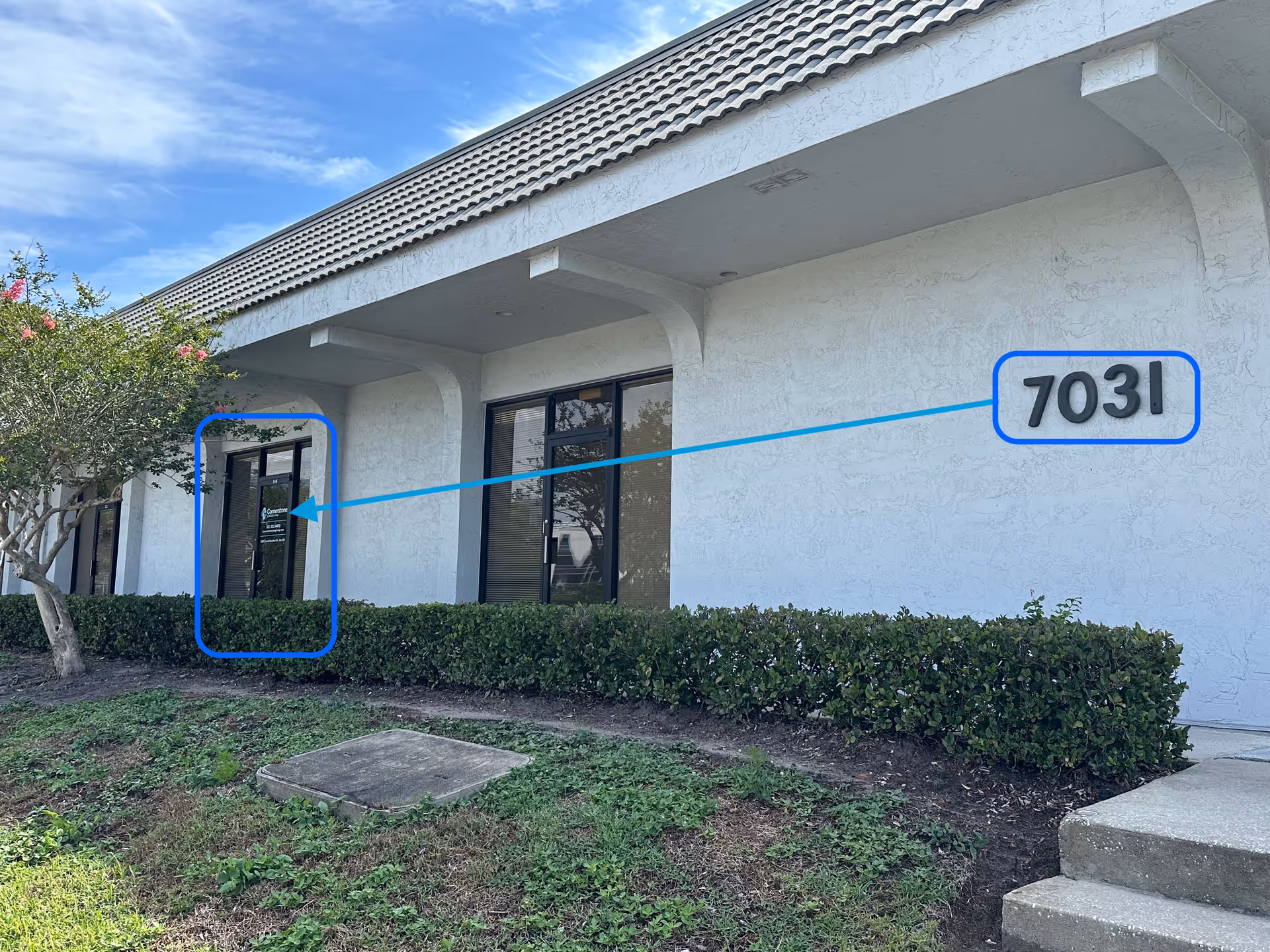 Exterior view of Cornerstone Caregiving building with front door and address 7031