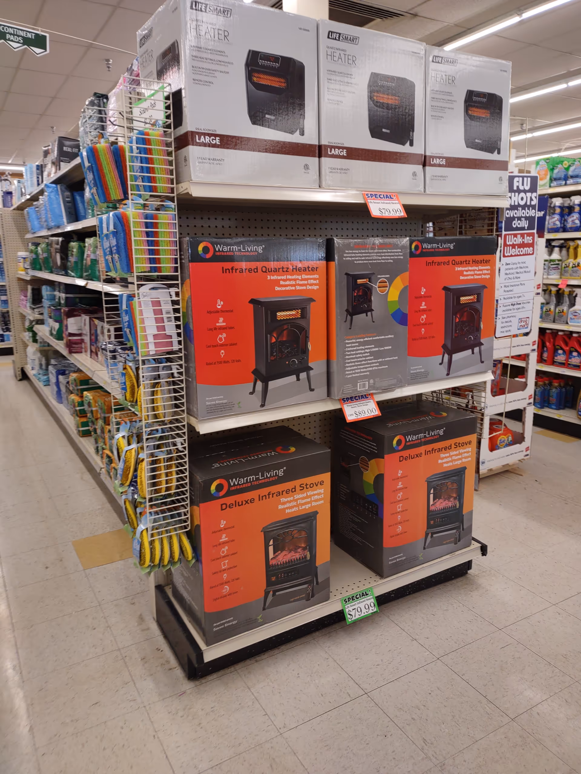 Aisle inside Discount Drug Mart featuring boxed heaters and appliances on shelves.