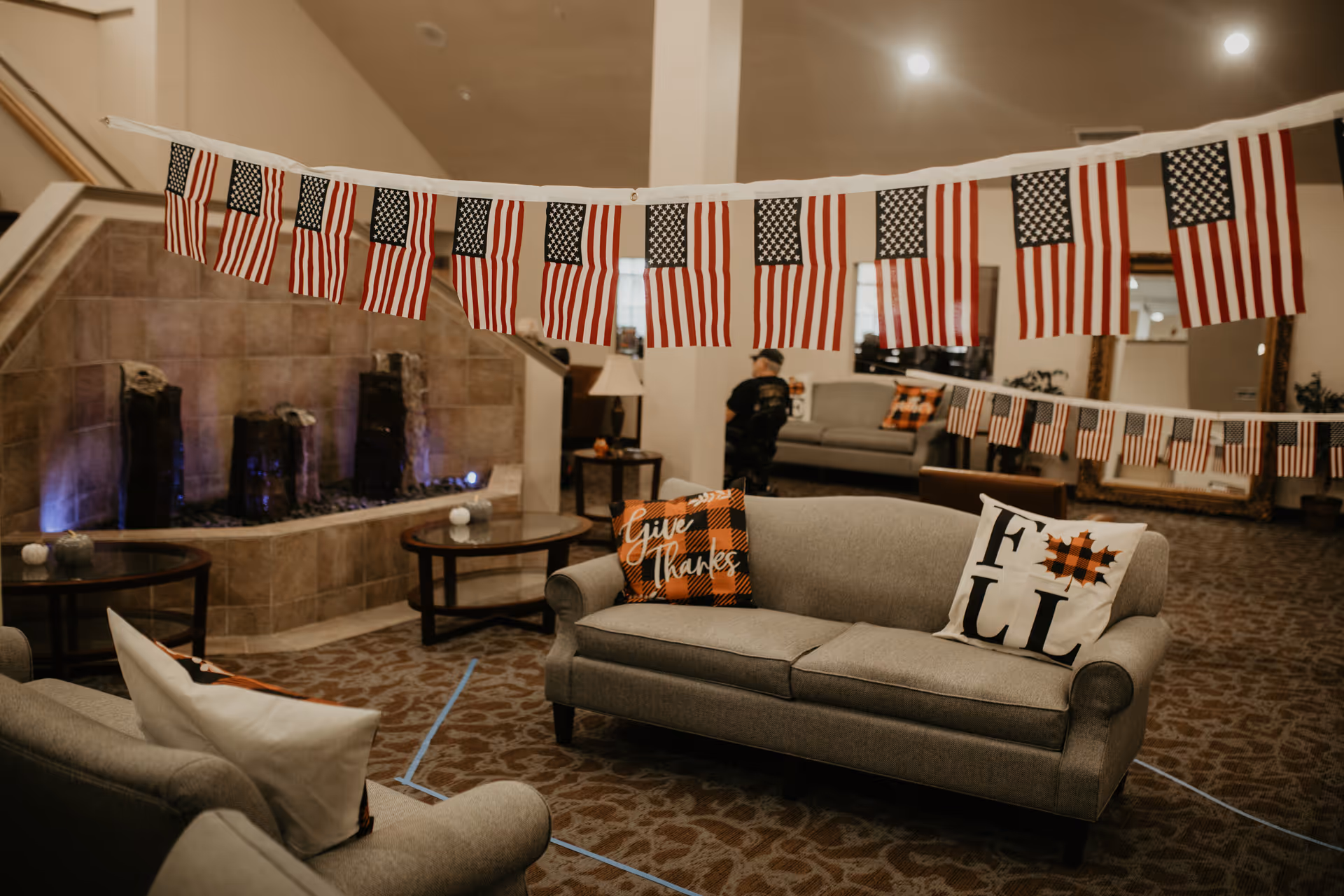 Cozy living room lounge with American flags and comfortable seating.