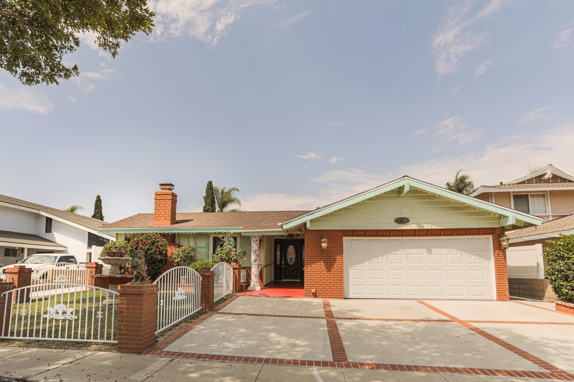 Front view of a single-story brick facility with a gated yard.
