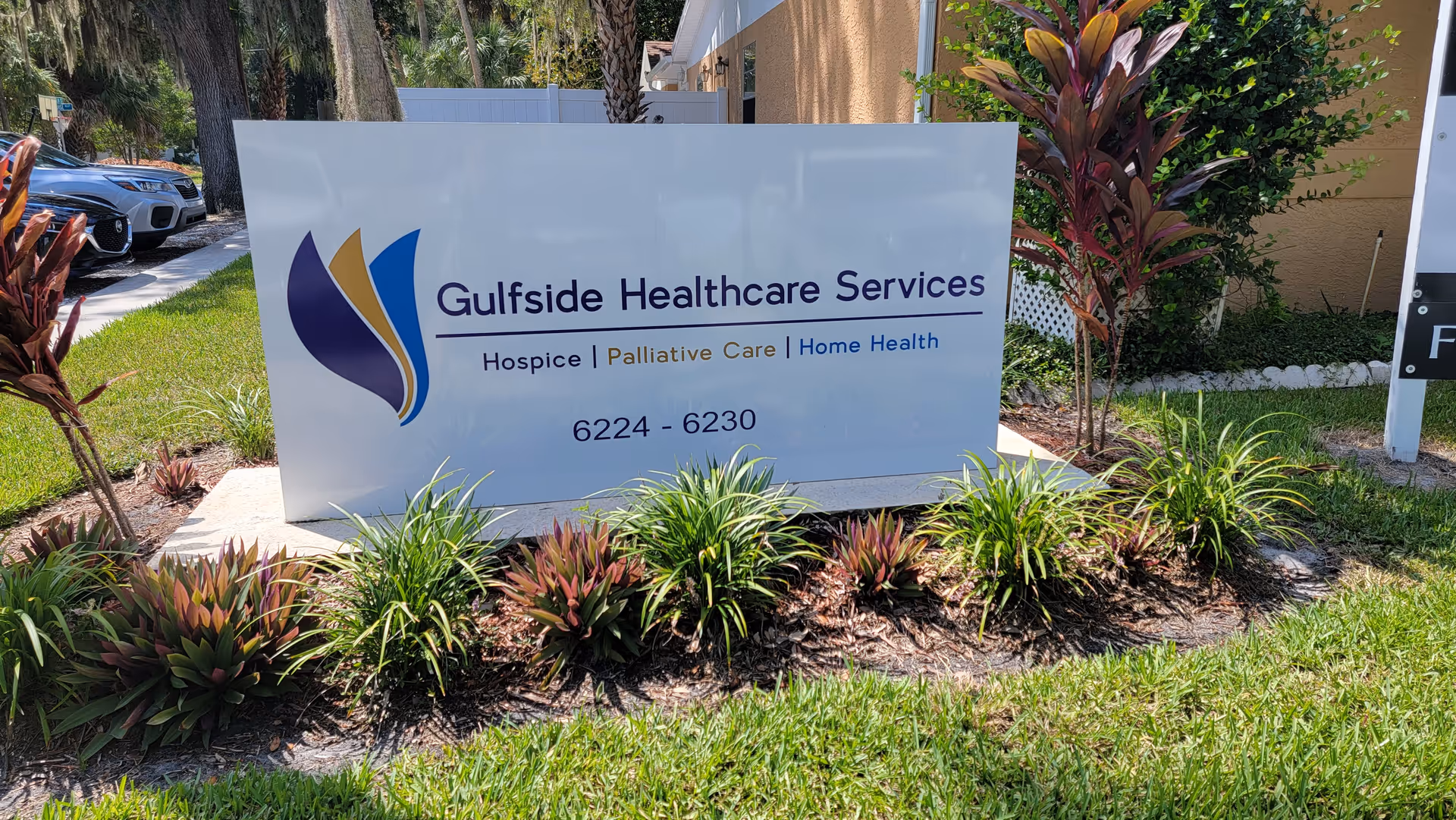 Large outdoor Gulfside Healthcare Services sign with surrounding landscaping in front.