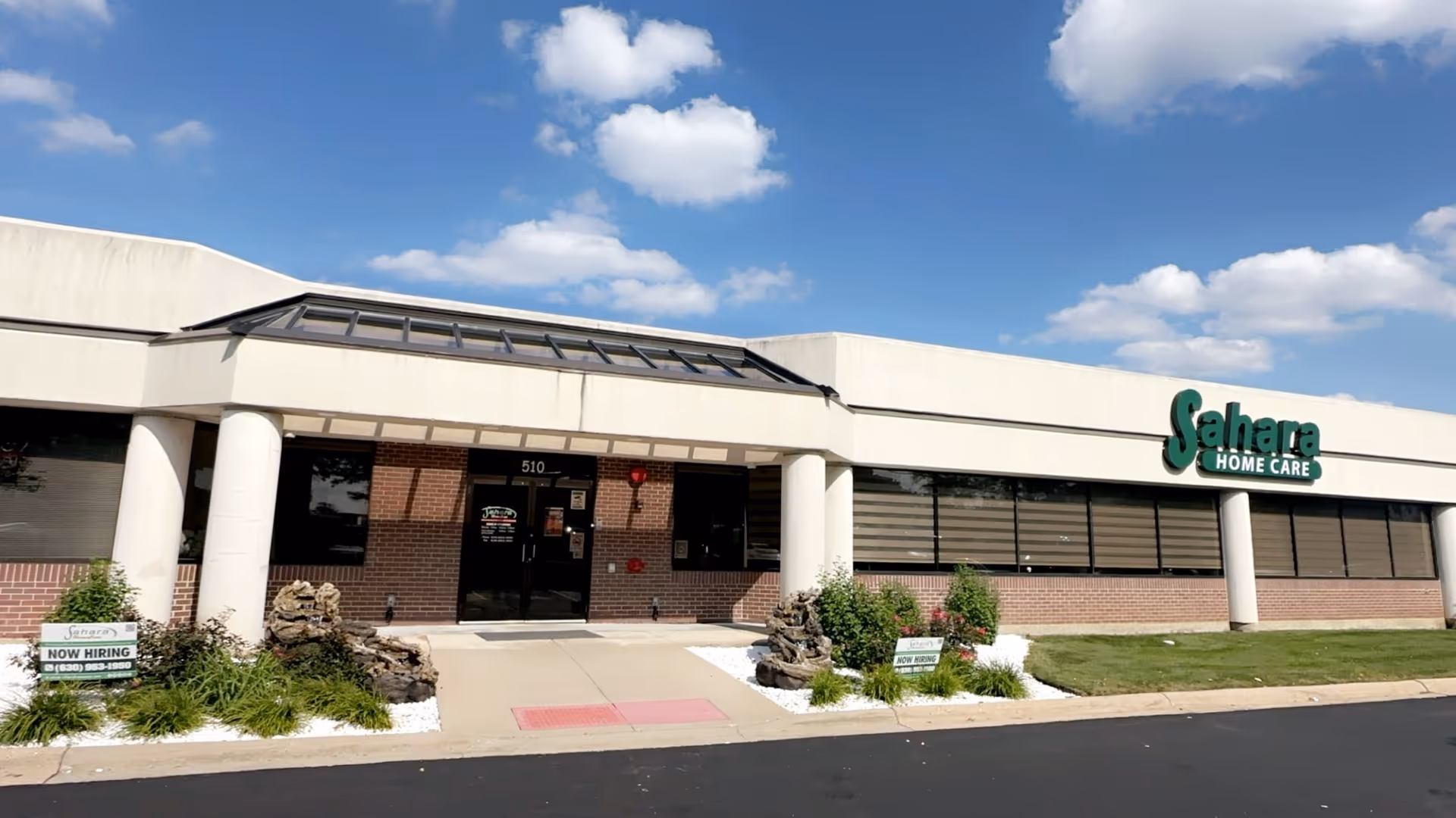 Front view of Sahara Home Care building with glass doors and manicured landscaping.