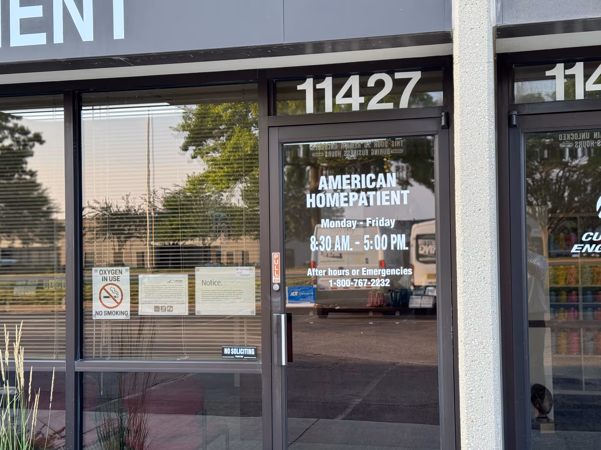 Exterior storefront for American HomePatient with glass doors and prominent number 11427.
