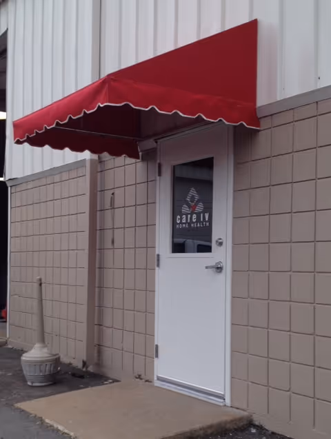 Exterior view of a Care IV Home Health entrance with a red awning.