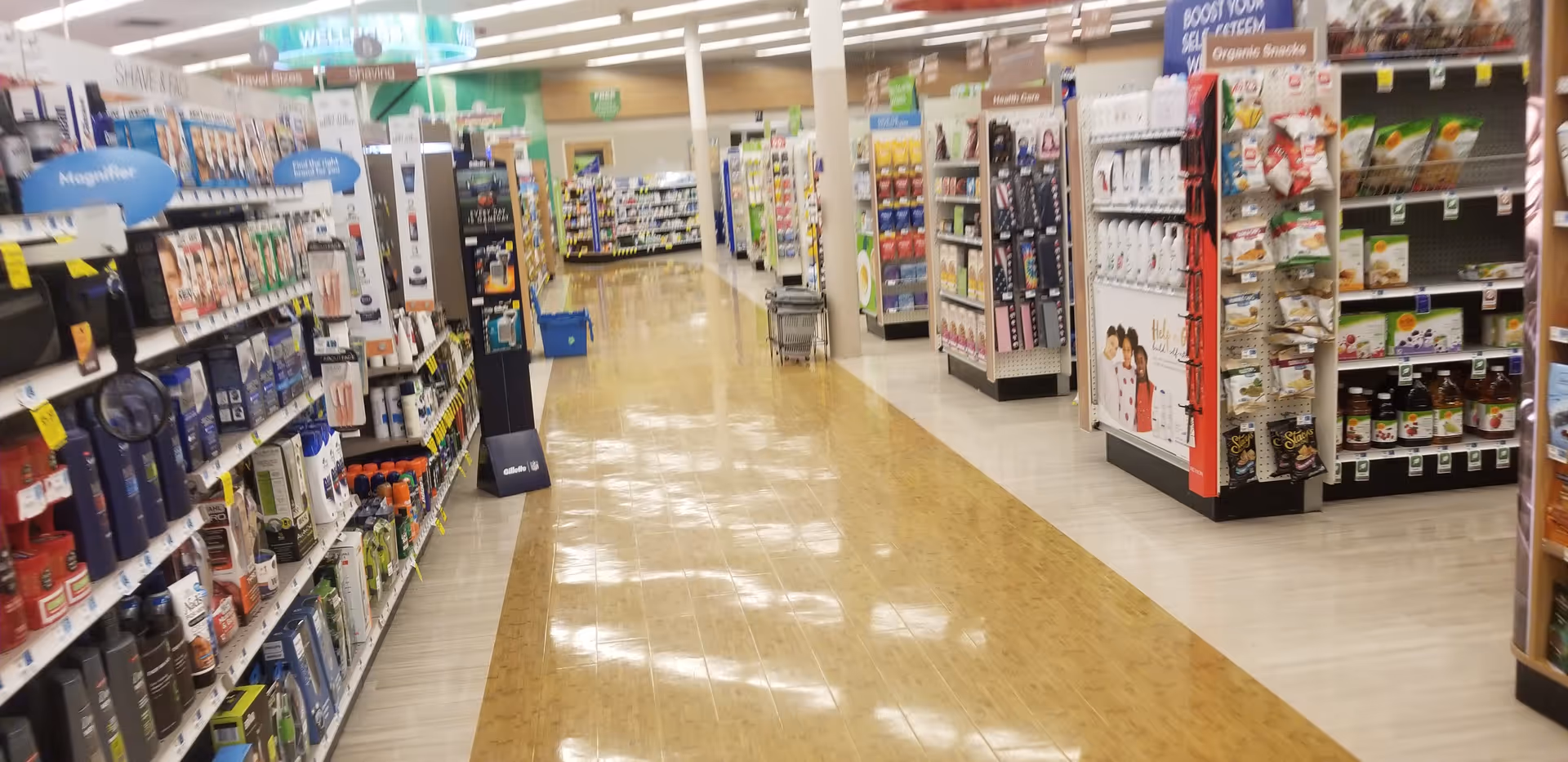 Interior of Discount Drug Mart showing a long aisle with shelves and products