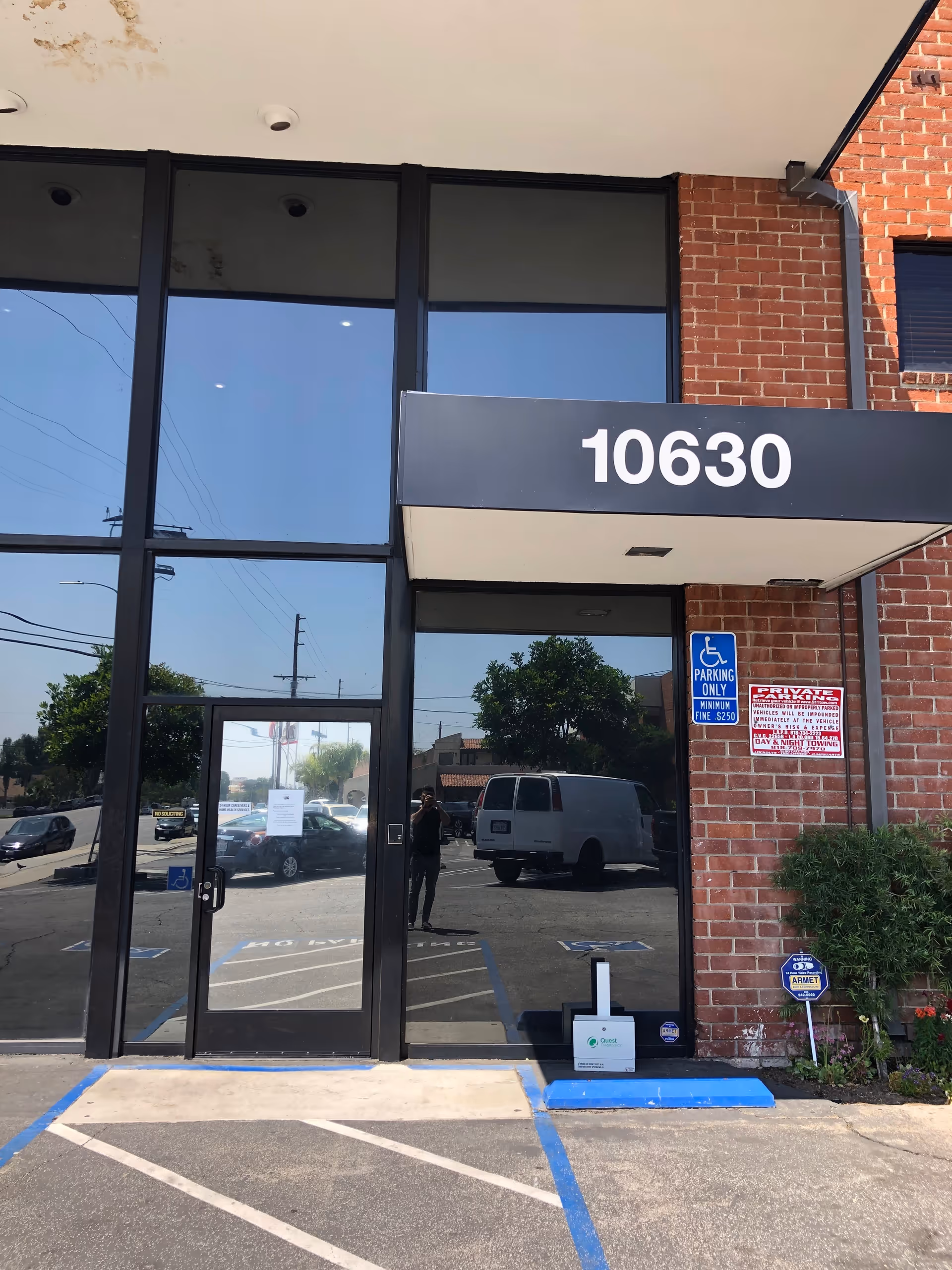 Glass-front brick building entrance with a large 10630 sign above the doorway.