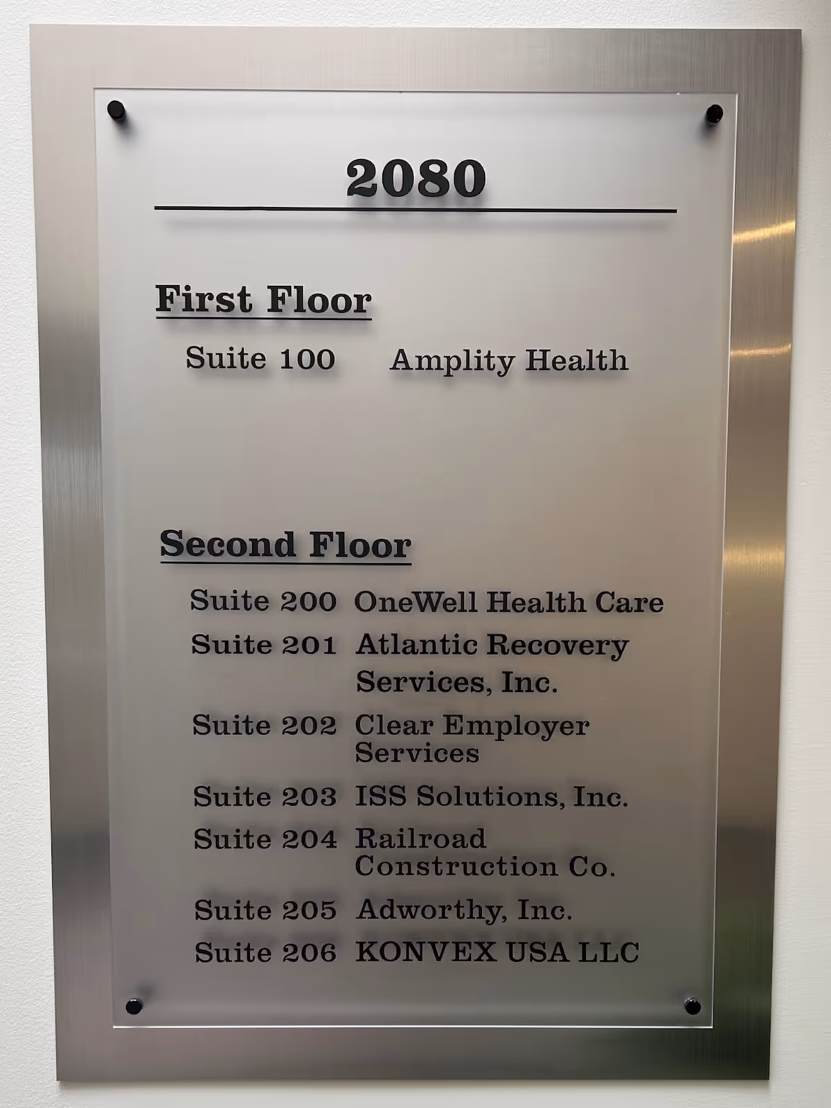 Two-floor metal directory sign listing suites for OneWell Health Care.