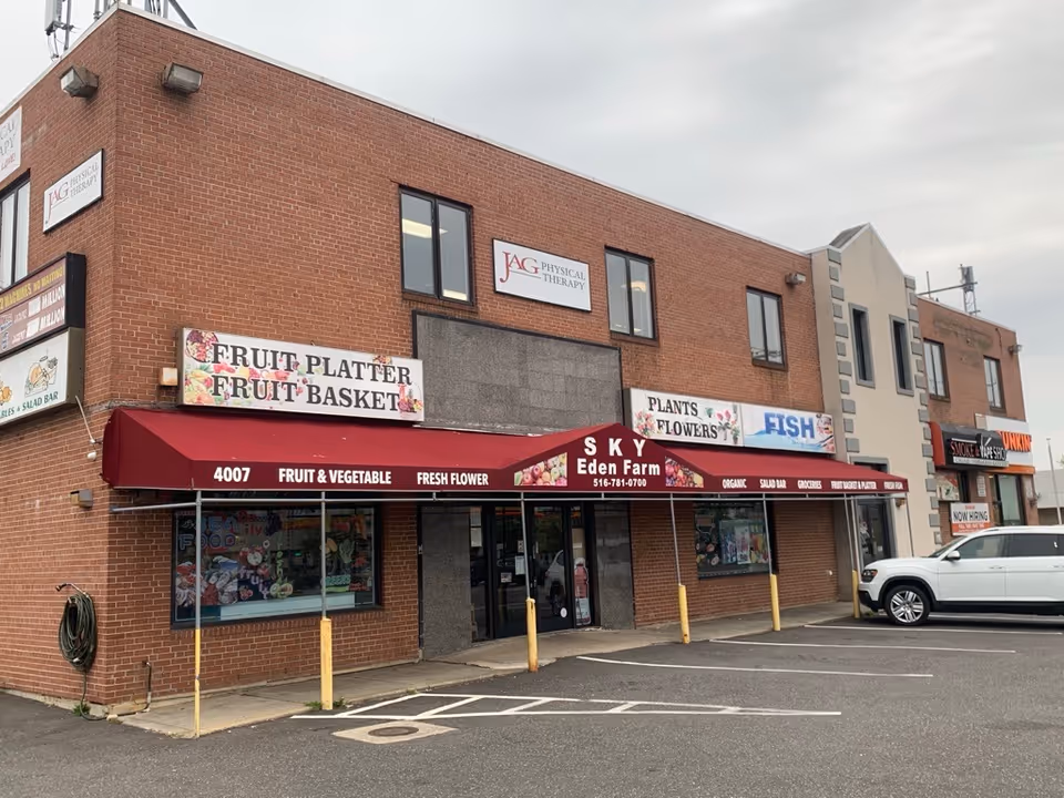 Brick storefront building with JAG Physical Therapy sign and red awnings.