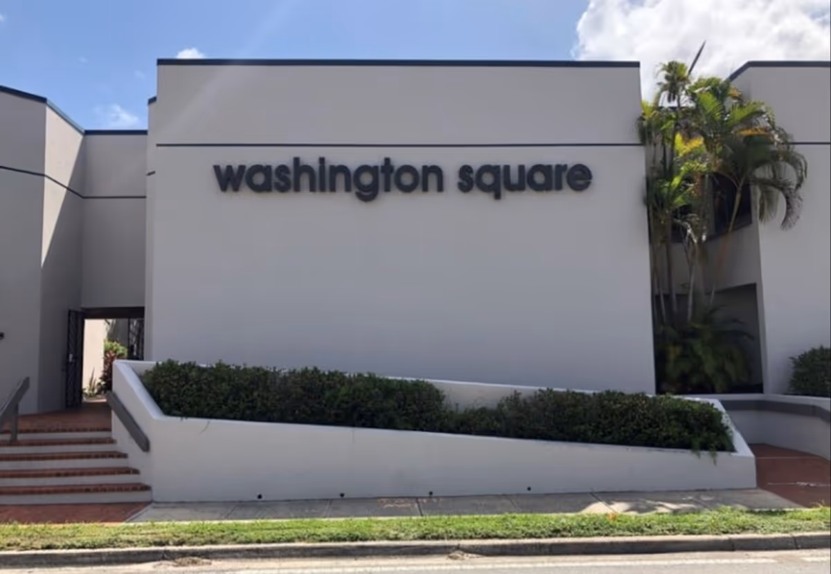 Exterior view of a modern building with a large 'washington square' sign.
