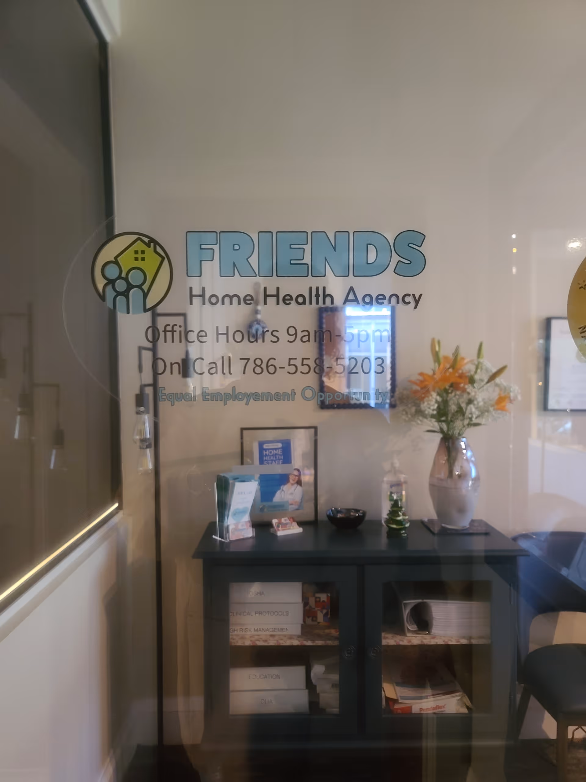 Interior lobby with glass front desk showcasing FRIENDS Home Health Agency branding.