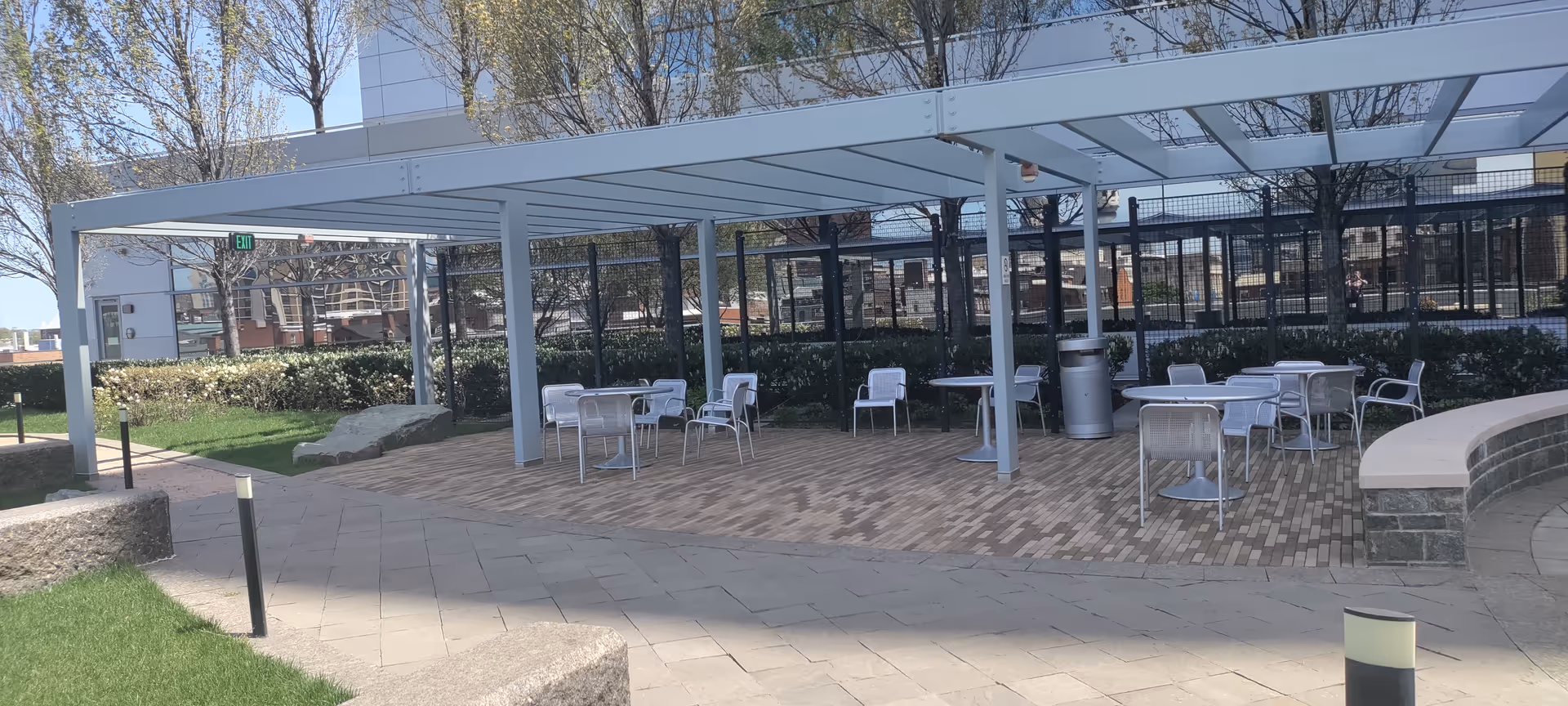 Mercy Medical Center outdoor seating area with tables and chairs beneath a pergola