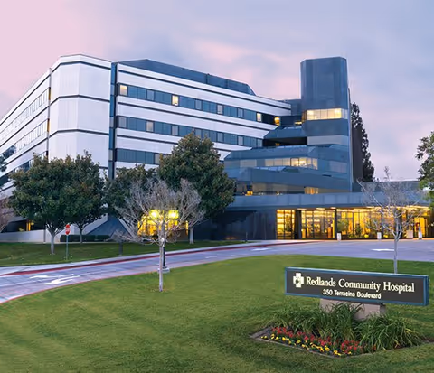 Exterior view of Redlands Community Hospital with entrance and landscaped grounds