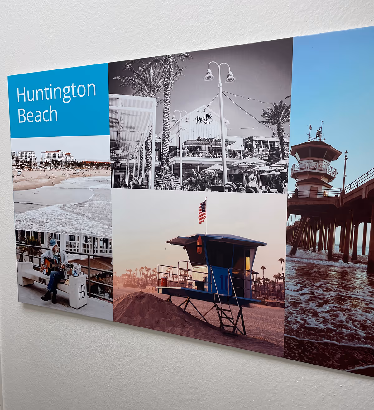 A multi-panel collage of Huntington Beach scenes mounted on a white interior wall.