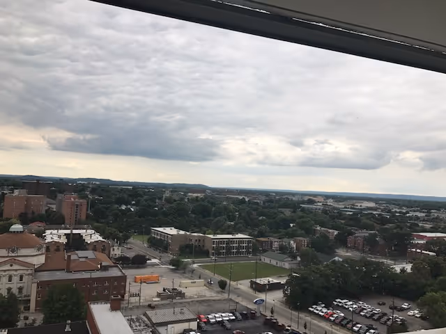 View of a cityscape and rooftops from a high window