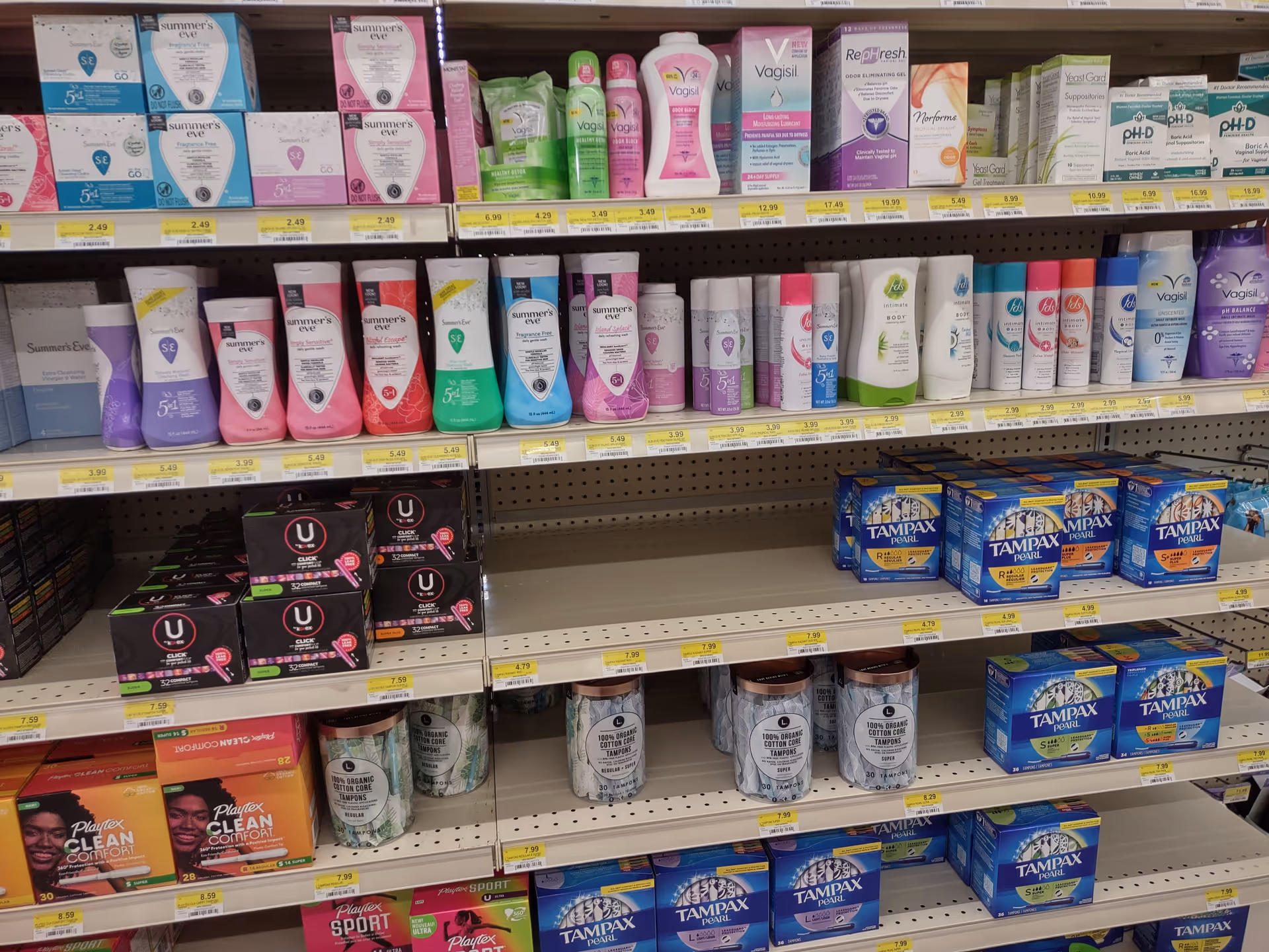 Aisle of personal care products on store shelves inside Discount Drug Mart.