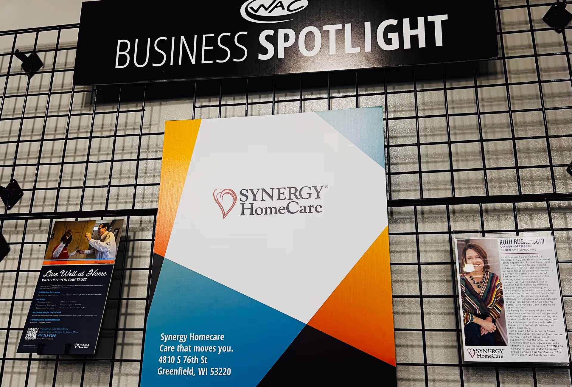 Interior display wall featuring a Synergy HomeCare brochure and Business Spotlight sign.
