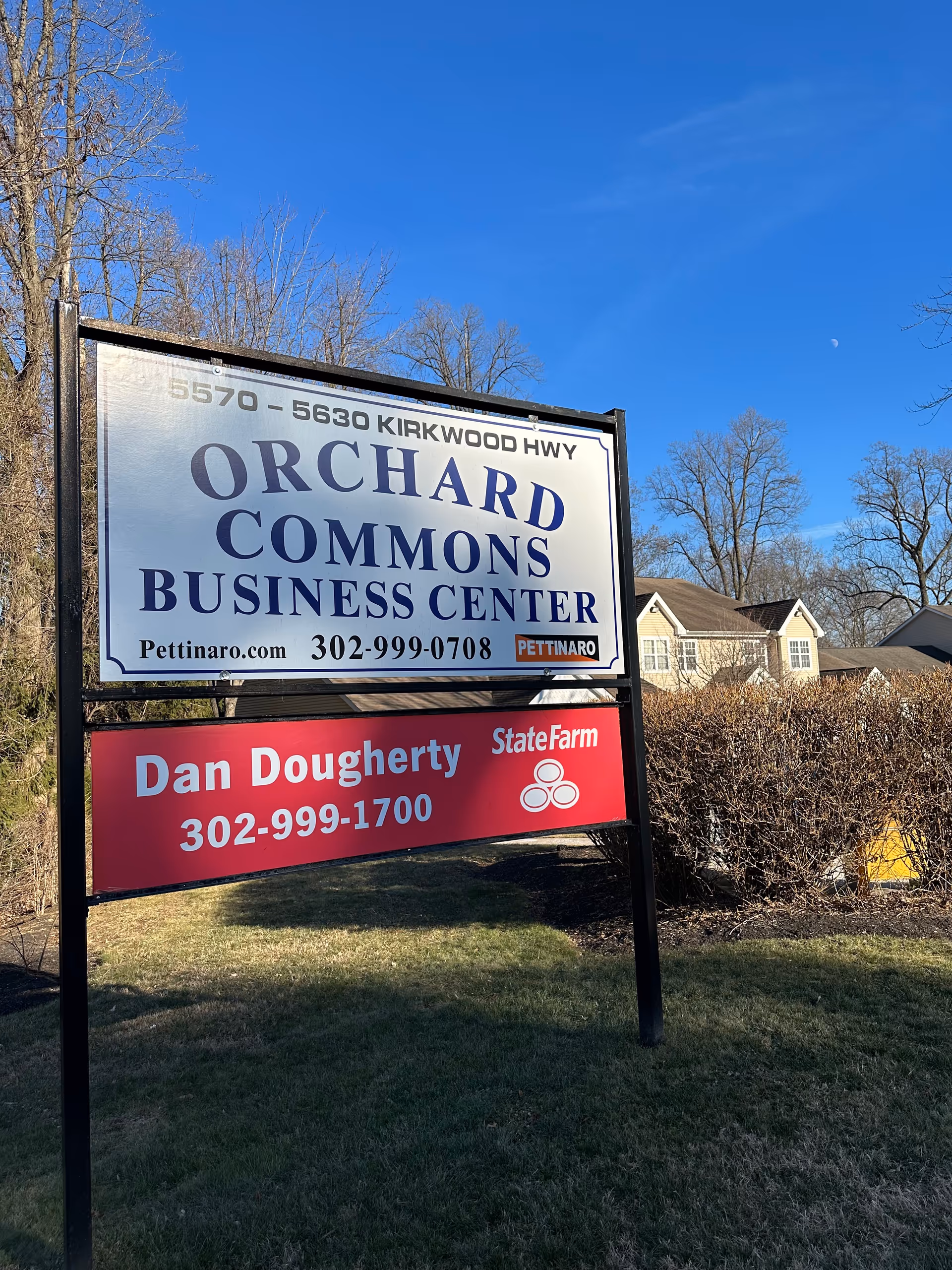 Outdoor sign display for Orchard Commons Business Center with Dan Dougherty State Farm branding.