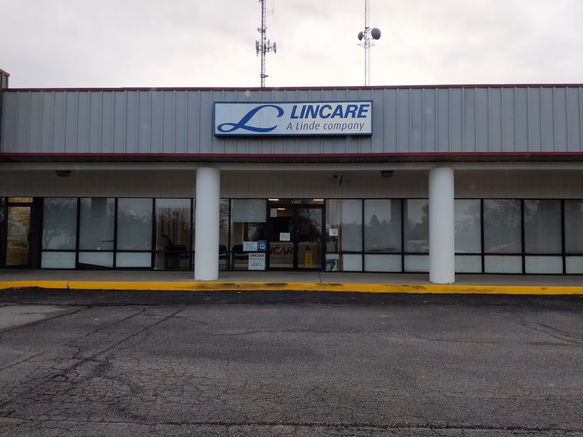 Exterior view of a LINCARE storefront with glass windows, entrance doors, and white columns.