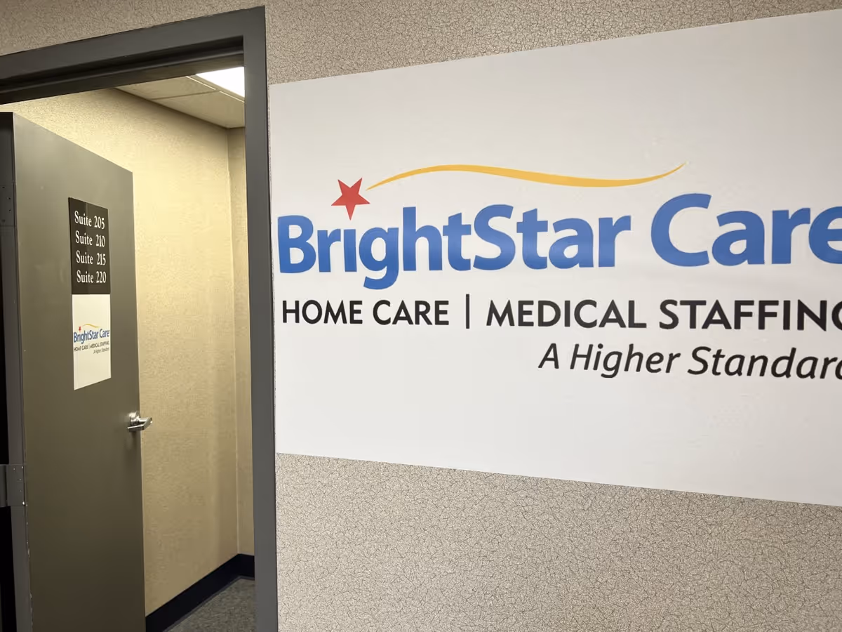 Interior hallway featuring BrightStar Care sign on wall and a doorway with room numbers.