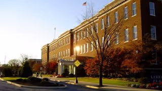 Brick exterior of a senior living facility with trees and a front entrance.