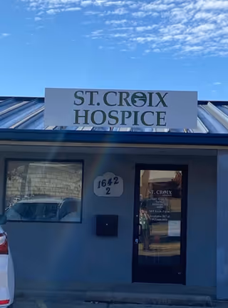 Front view of a blue building with a St. Croix Hospice sign above the entrance.