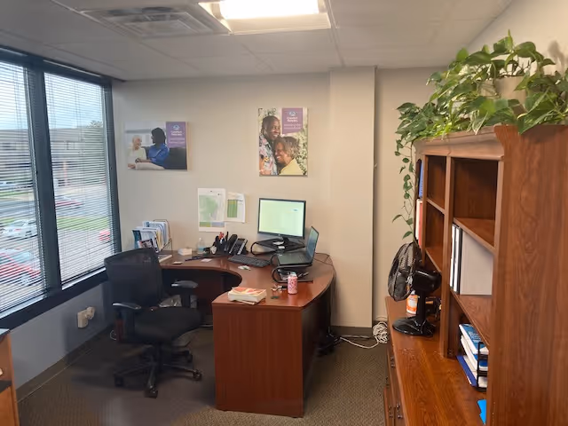 Office workspace in Comfort Keepers Home Care with desk, computer, and shelving.