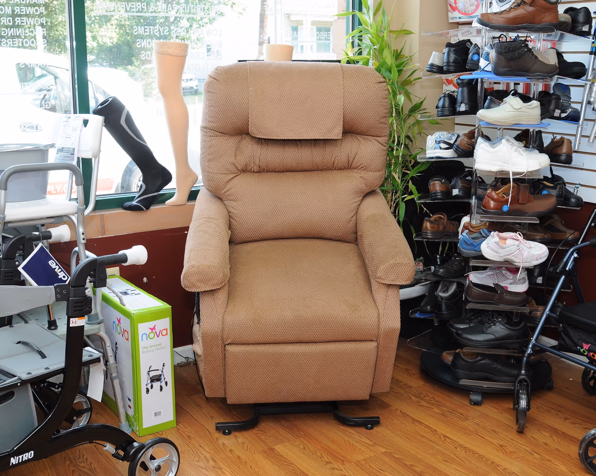 Beige recliner chair surrounded by shoe displays and mobility equipment in an indoor showroom.