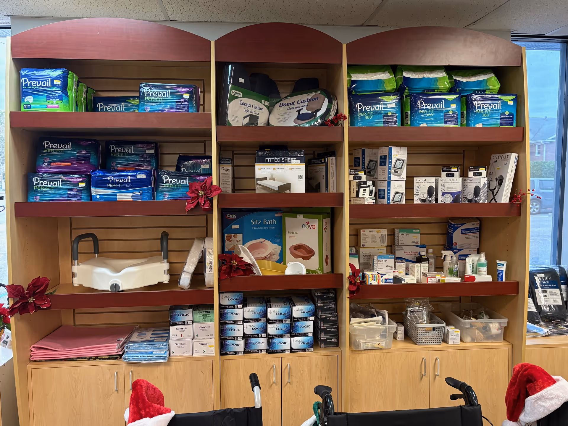 Diapers and medical supplies line the wooden shelves in a clinic supply room.