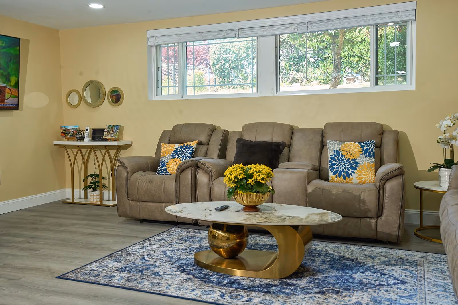 Cozy living room in Apex Care Adult Family Home with beige couches and a coffee table.