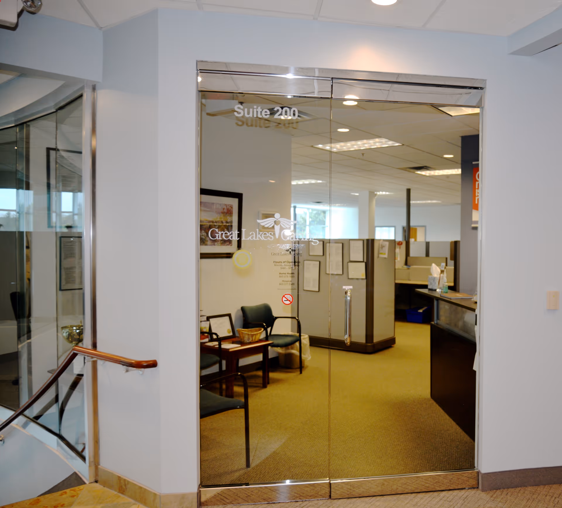 Glass double doors showing Suite 200 and a waiting area with chairs.
