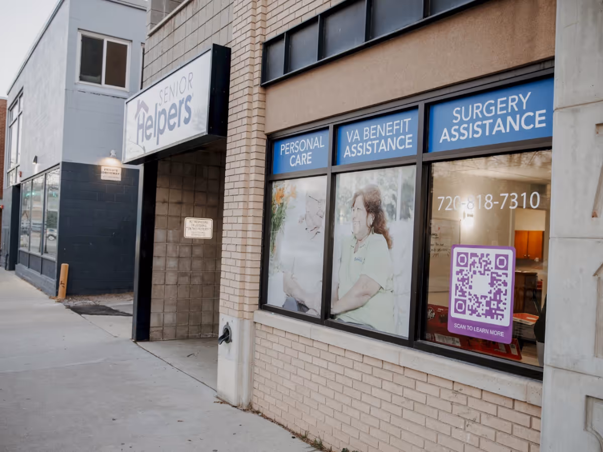 Exterior of Senior Helpers storefront with windows displaying care service signs