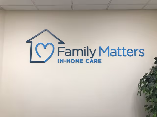 Interior wall with house-outline logo and blue text.