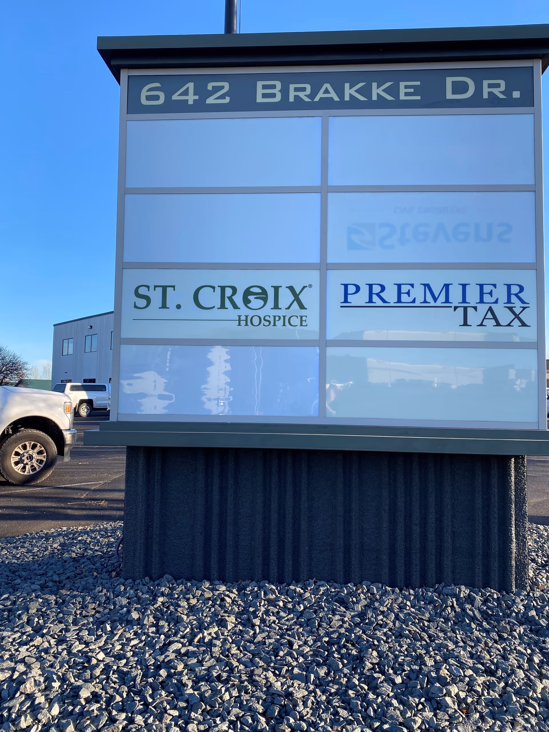 Exterior sign displays 642 Brakke Dr and logos for St. Croix Hospice and Premier Tax.