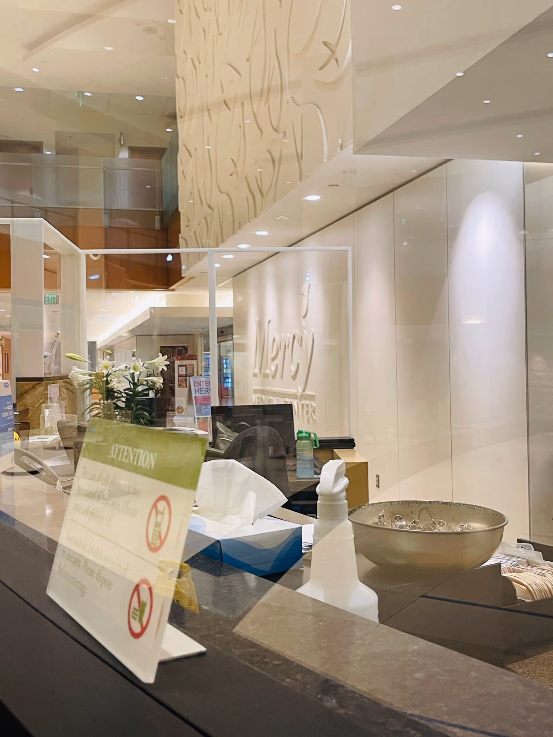 Mercy Medical Center lobby reception with glass walls and signage.