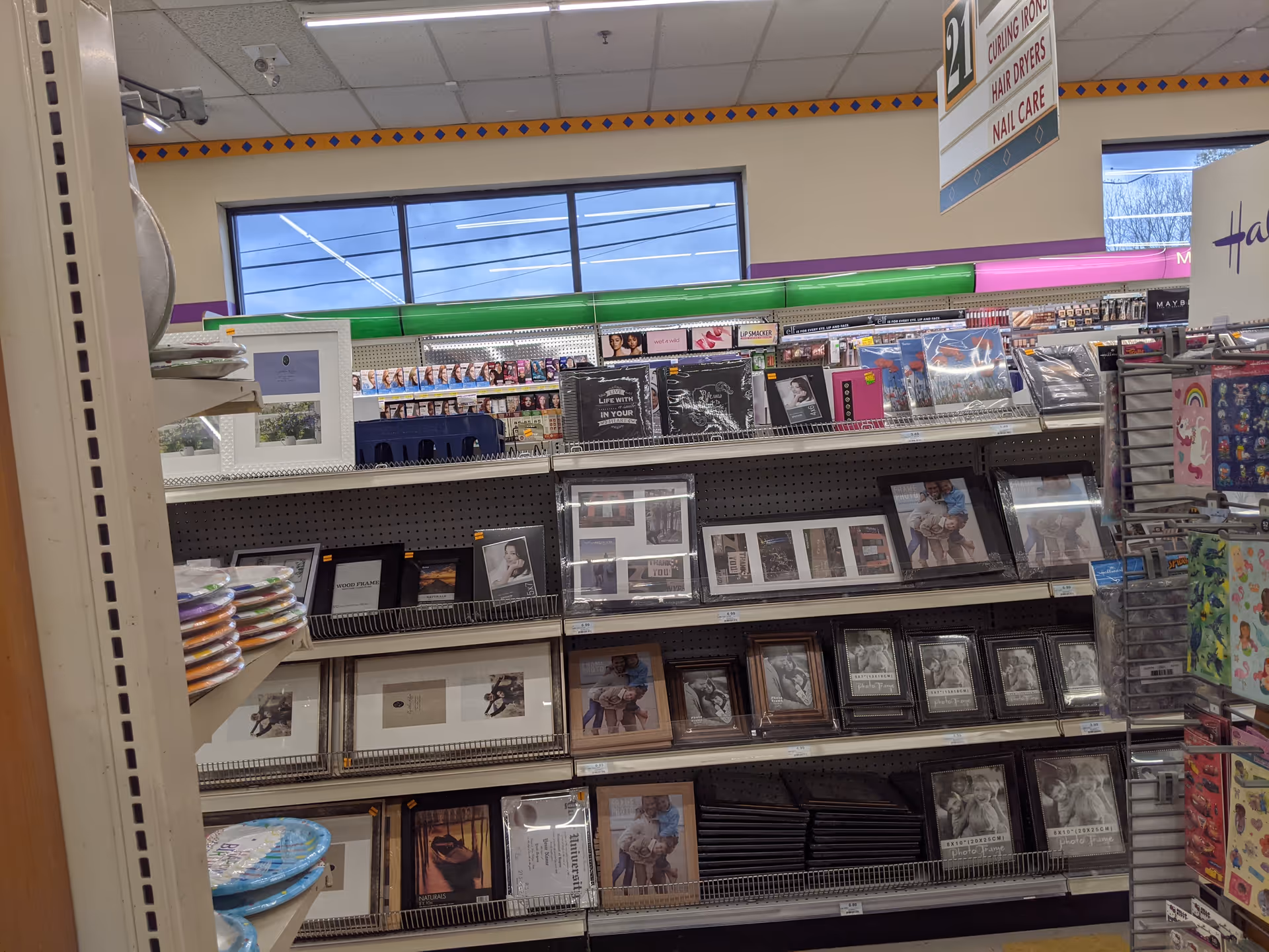 Interior of Discount Drug Mart with shelves of framed photos and gifts.