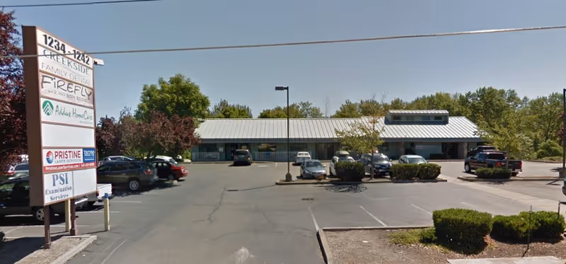 Exterior view of Addus HomeCare facility with a single-story building, parking lot, and sign.