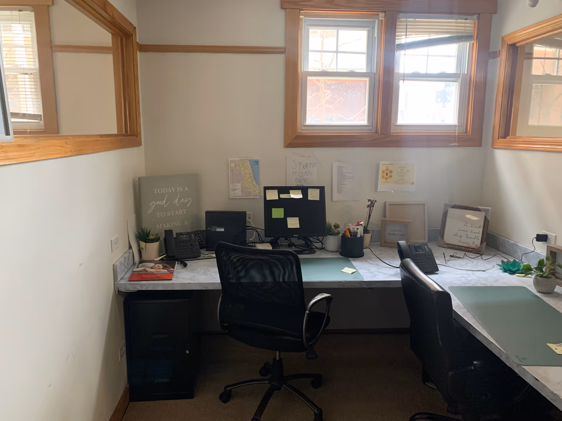 Interior office area with desks, computers, and motivational decor in a SYNERGY HomeCare facility