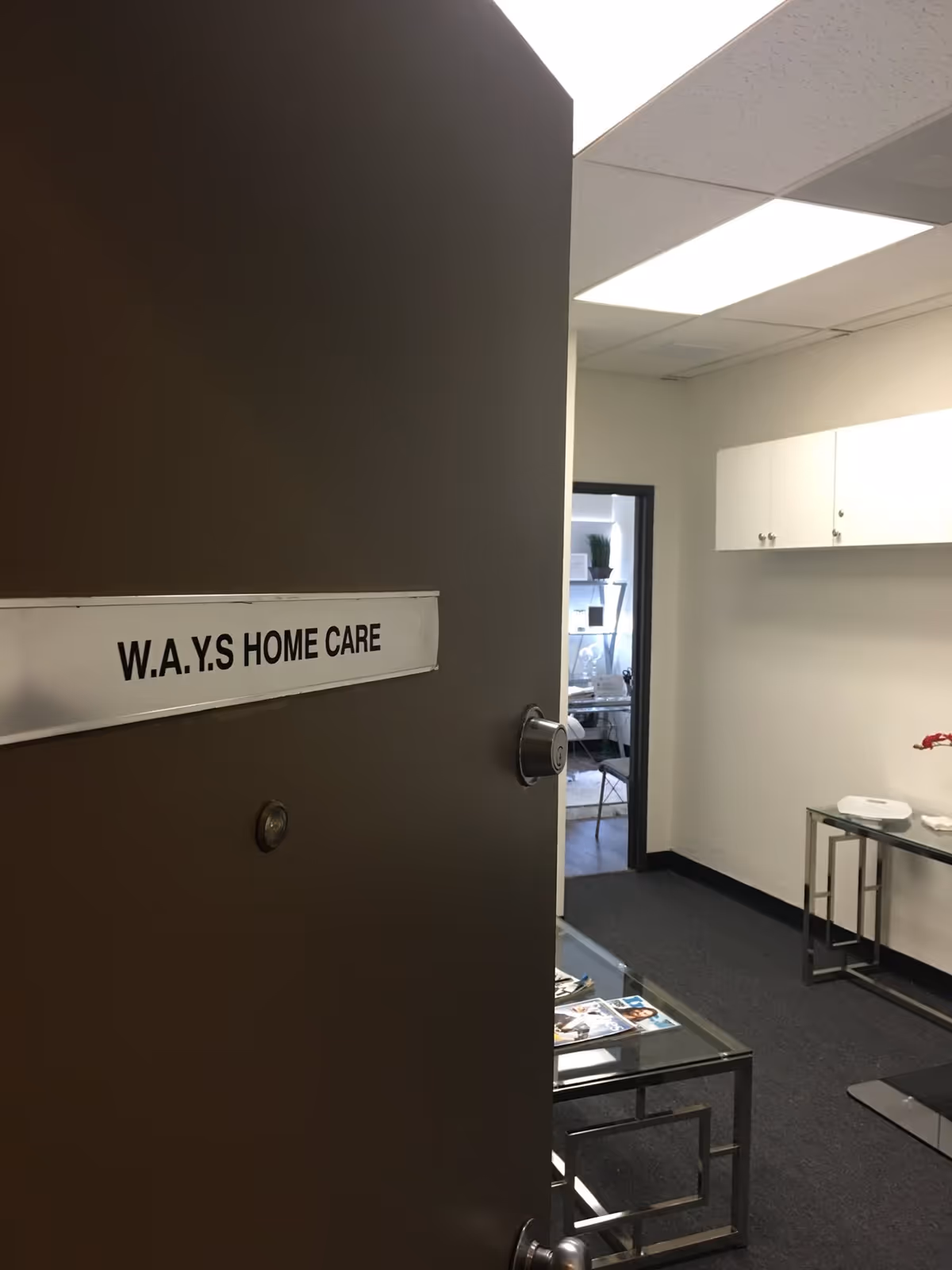 Interior hallway with a door labeled W.A.Y.S HOME CARE and a small waiting area.
