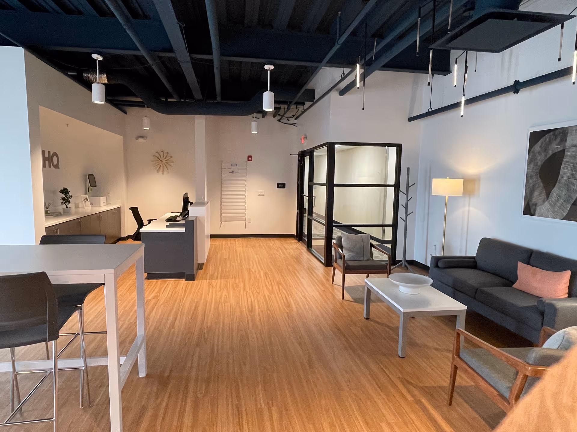 Open senior living lobby with sofa seating, coffee table, and reception desk.