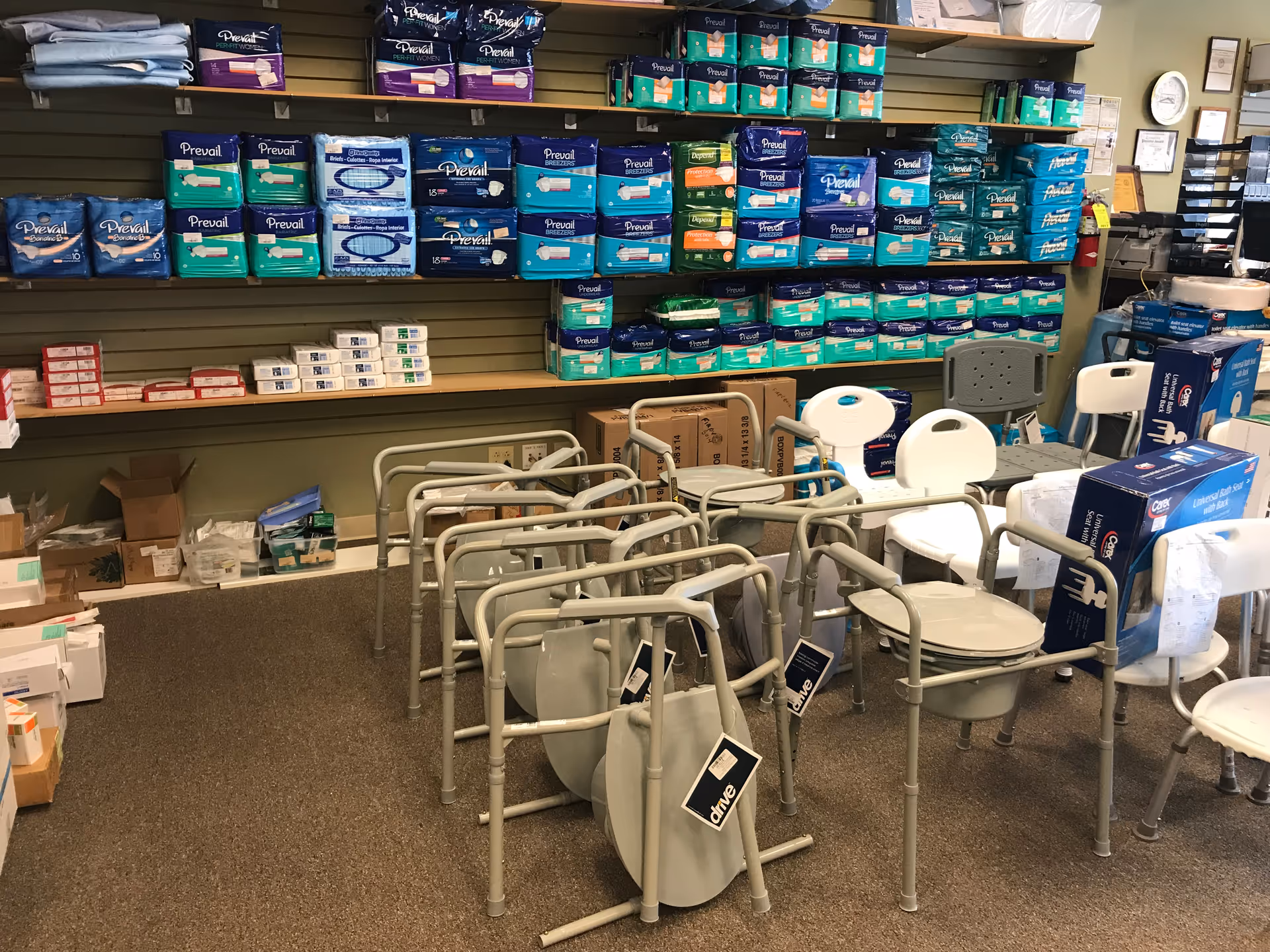 Interior room stocked with adult diapers and mobility aids, with chairs and walkers.