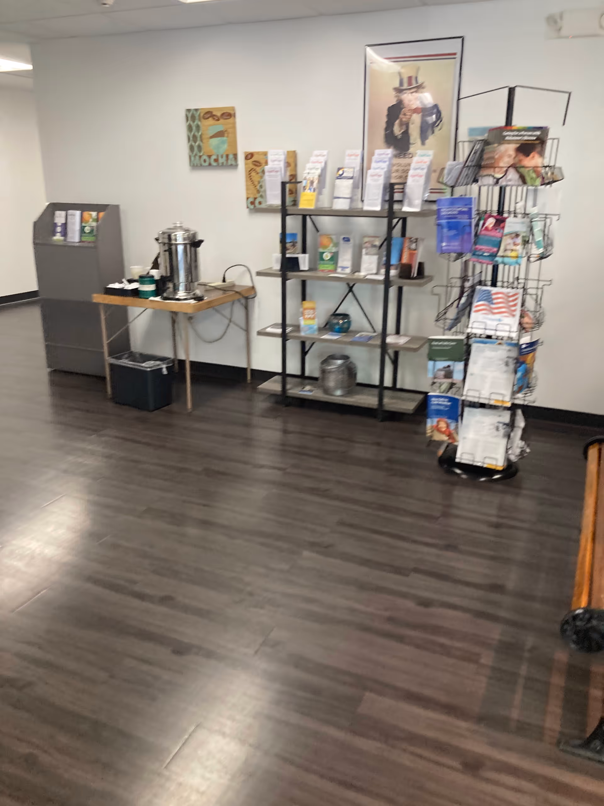 Senior living facility lobby with coffee station, brochures, and a magazine rack.
