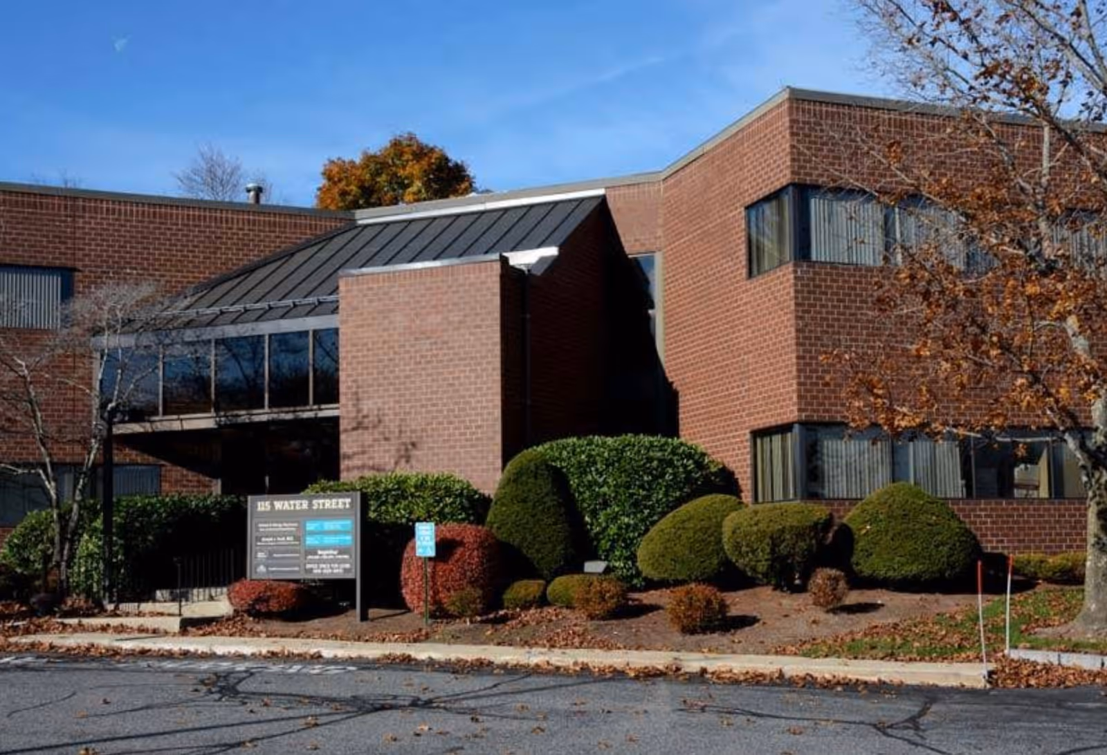 Brick exterior of a BrightStar Care facility with landscaped shrubs and blue sky.