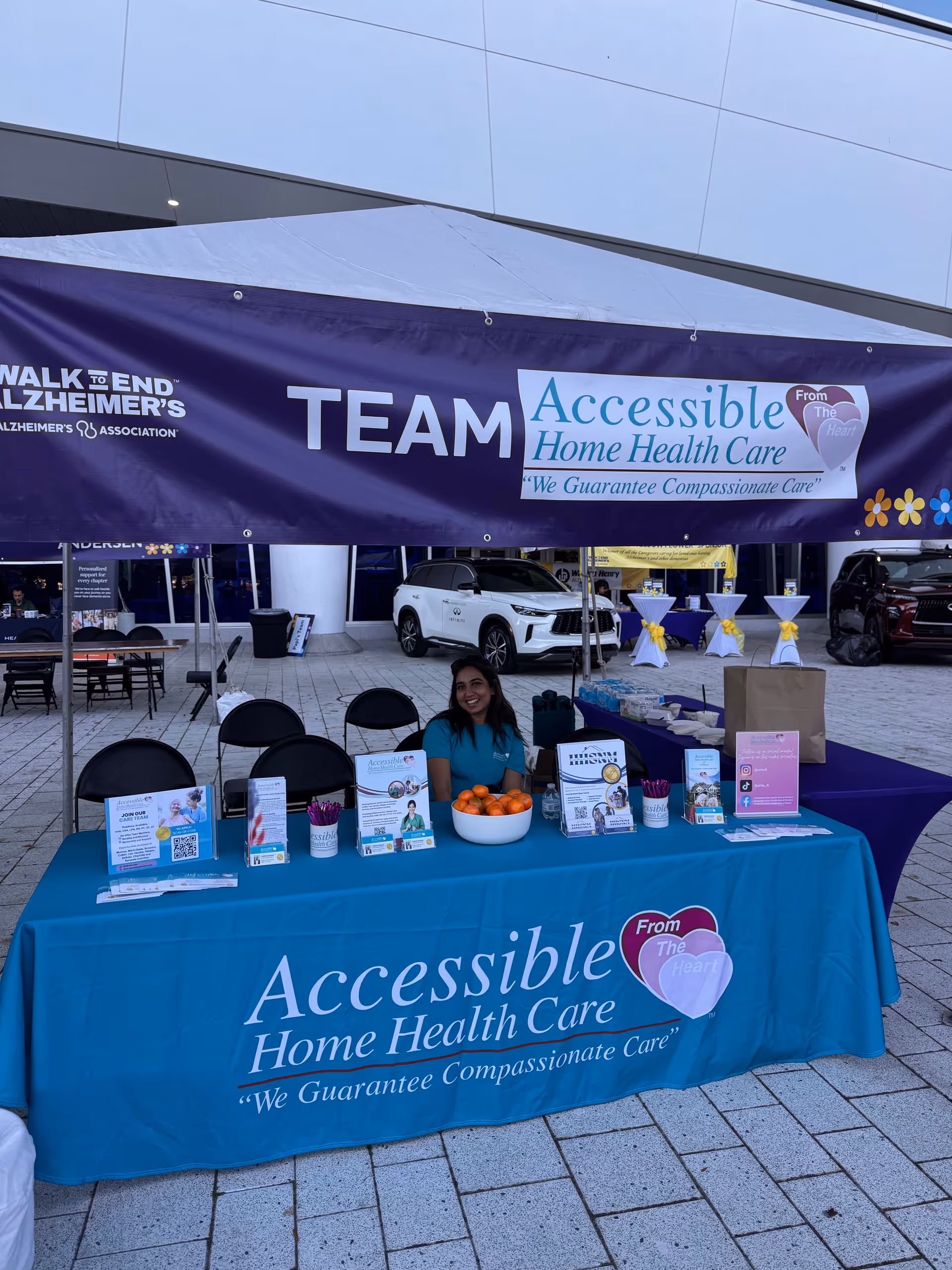 Outdoor event booth for Accessible Home Health Care of Naples with a blue tablecloth.