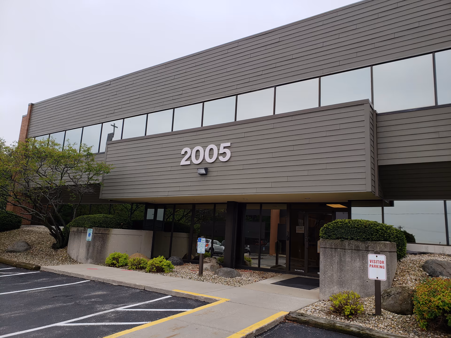 Modern building exterior with large windows and the number 2005 on the facade